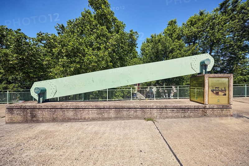 Hindenburg Bridge monument, historic chain link of a suspension bridge, metal railing, concrete slab walkway, trees, blue sky, cloudless, Deutz bridge, Cologne, district-free city, North Rhine-Westphalia, Germany