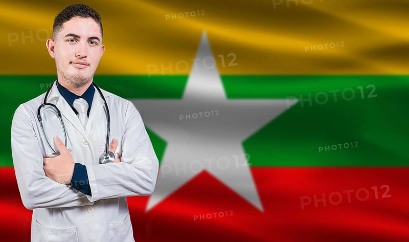 Portrait of medical professional on Myanmar flag background. Burmese national health system