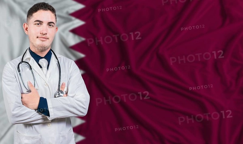 Portrait of medical professional on Qatar flag background. Qatari national health system
