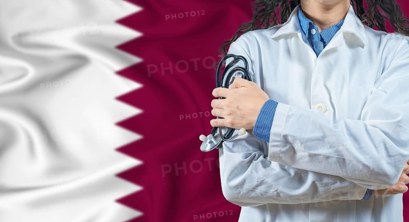Healthcare professional with Qatar flag background. Professional doctor holding stethoscope on Qatar flag background