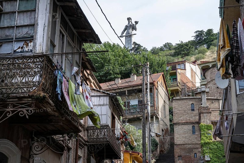 Tbilisi, Georgia. July 15th 2025. The Mother of Georgia statue seen from the narrow side streets and old houses of Tbilisi Old Town, Georgia