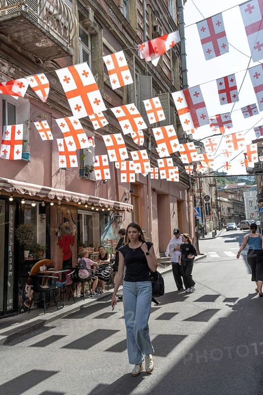 Tbilisi, Georgia. July 7th 2025. Georgian flags flutter over a side street in the Old Town in Tbilisi, Capital of Georgia