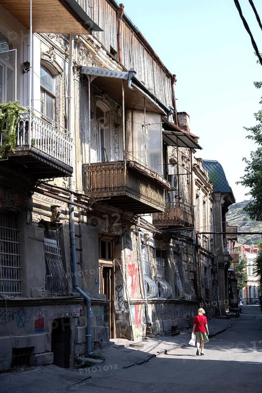 Tbilisi, Georgia. July 29th 2025. A women walks in the quiet streets of Tbilisi old town, with its narrow streets and traditional architecture. Georgia