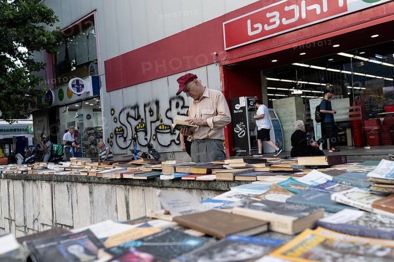 Tbilisi, Georgia. July 7th 2025. A local man browses secondhand books at a street market near the University of Georgia, Tbilisi, Georgia