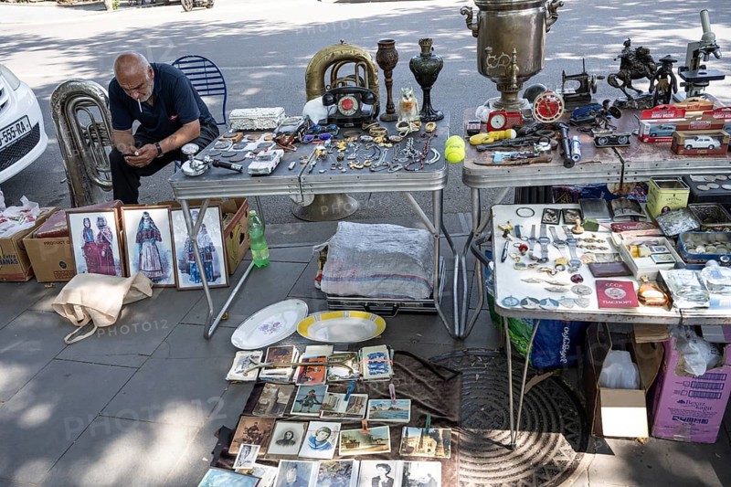 Tbilisi, Georgia. July 11th 2025 Street stall vendor at the Dry Bridge Flea Market selling antiques and old Soviet memorabilia in Tbilisi Old Town near the River Kura