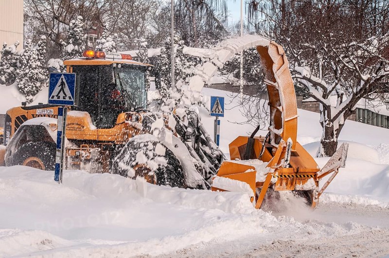 Snow blower clears snow on street in Ystad, Skåne County, Sweden, Scandinavia