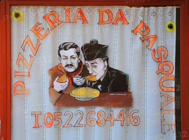 Italy, village of Brescello, advertisement for Pizzeria Pasquale, with a picture of Don Camillo and Peppone