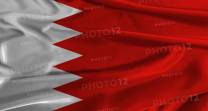 Flag of Bahrain with fabric textured background. Close up of National flag of Bahrain with realistic texture