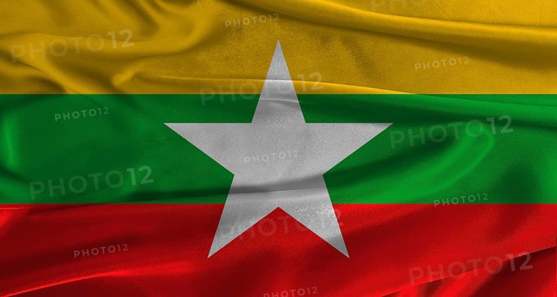 Flag of Myanmar with fabric textured background. Close up of National flag of Myanmar with realistic texture