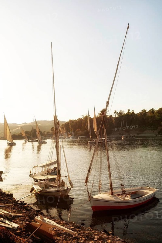 Aswan, Egypt. December 10th 2022 Felucca sailing boats at evening time at Elephantine Island on the River Nile, Aswan, Egypt