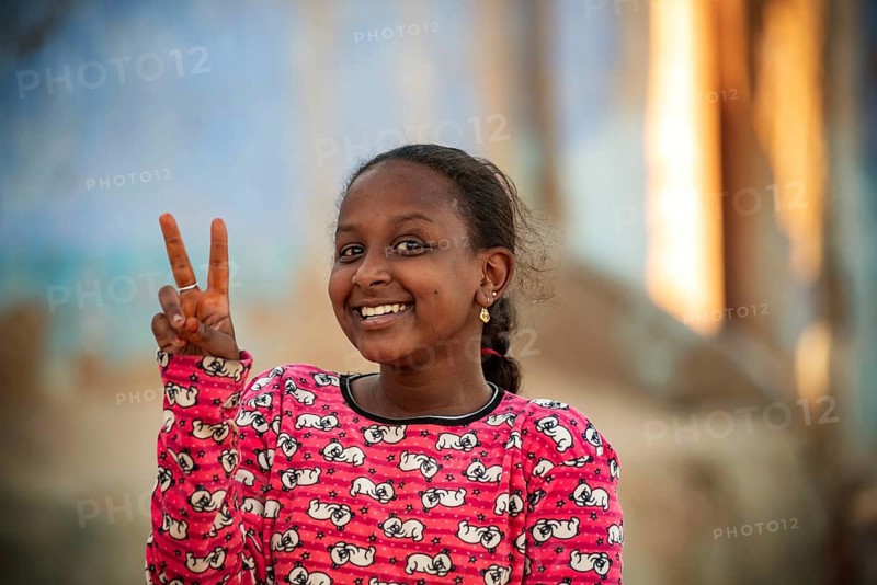 Aswan, Egypt. December 10th 2022 Pretty happy smiling young Nubian girl in the Nile side Nubian Village near Aswan in Upper Egypt