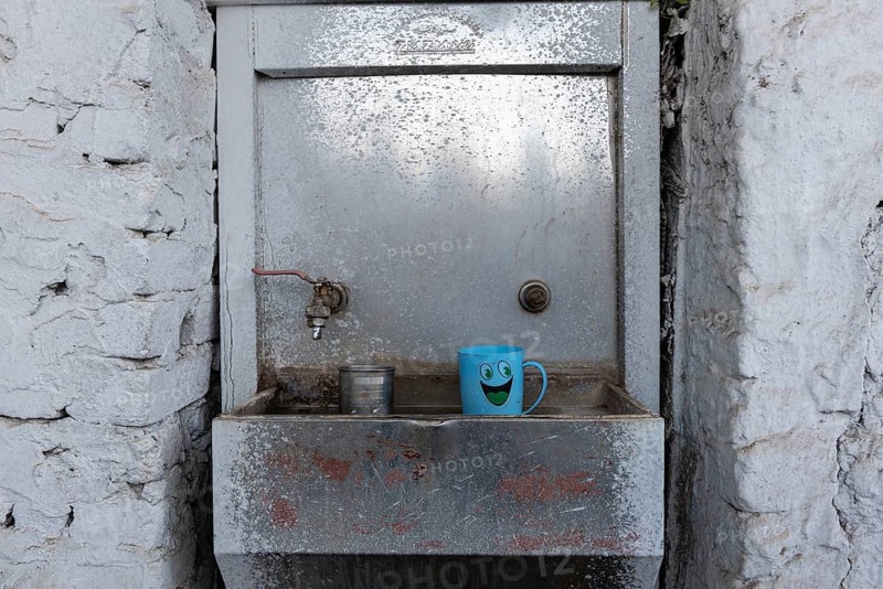 Aswan, Egypt. December 9th 2022 Cean water drinking fountain with plastic smiley face mug, along the Nile River in Upper Egypt near the city of Aswan, Egypt