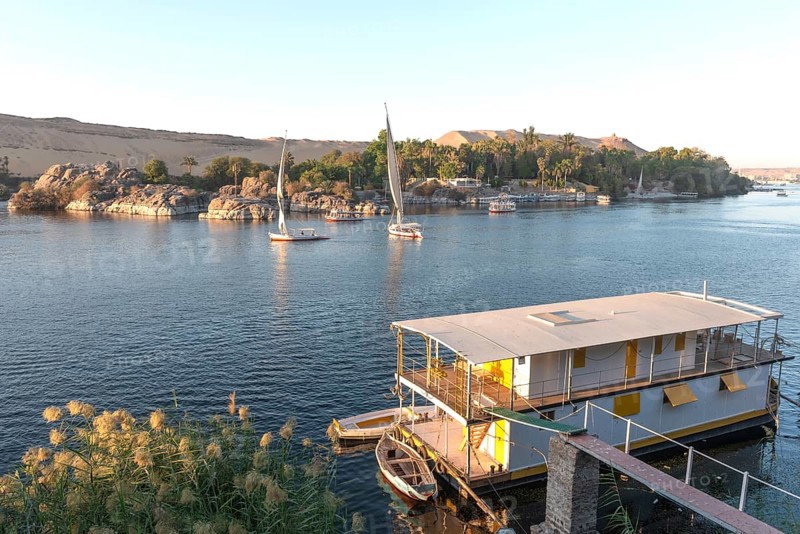 Aswan, Egypt. December 9th 2022 Beautiful scenic view of an Egyptian house boat on the River Nile from Elephantine Island, Aswan, Egypt
