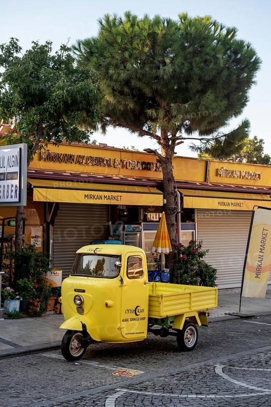Akyaka, Mugla, Turkey. September 8th 2022 A bright yellow delivery van parked outside a market shop in the Cittaslow Turkish Riviera town of Akyaka in Mugla province of southwest Turkey