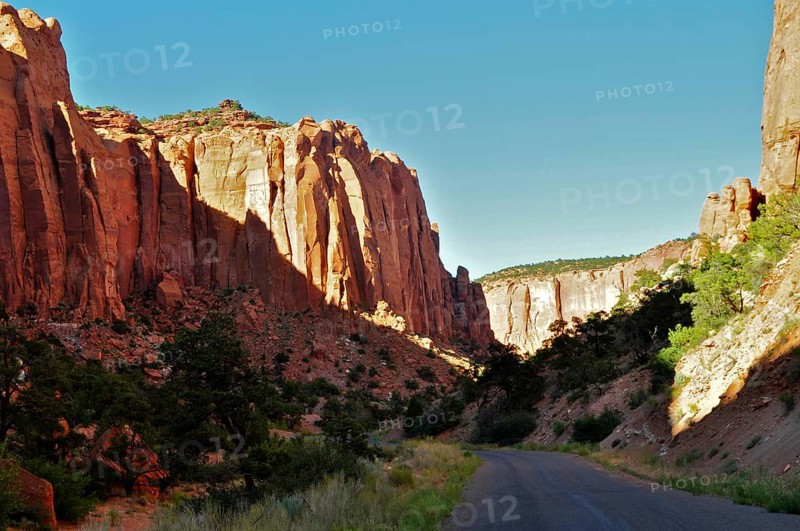 Tall rocks frame a road leading through a dramatic canyon landscape, Grand Staircase Escalante National Monument, Utah, USA