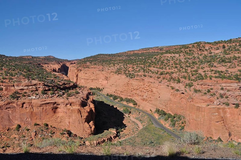 Road runs through a valley with impressive red rocks, Grand Staircase Escalante National Monument, Utah, USA