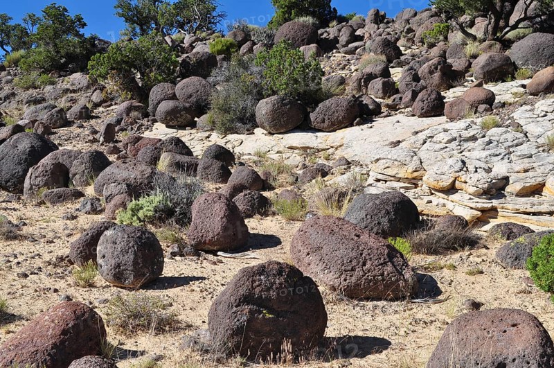 Large spherical rocks in an arid desert landscape, Grand Staircase Escalante National Monument, Utah, USA