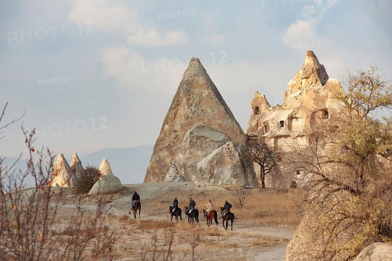 Cappadocia, Turkey. November 8th 2017 Canan a horse trekking guide from the Dalton Brothers Ranch leads a group of tourists through the volcanic landscape of Cappadocia in central Anatolia, Turkey