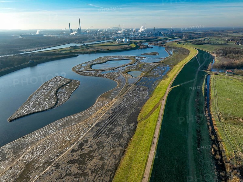 Haltern-Marl, North Rhine-Westphalia, Germany - Lippe, flood protection in the Haltern-Lippramsdorf-Marl area (HaLiMa) . Flood protection on the River Lippe by relocating the dyke and thus extending the floodplain. On the right, the completed floodplain north, the north dyke. Work is still underway on the south dyke. Marl Chemical Park in the back