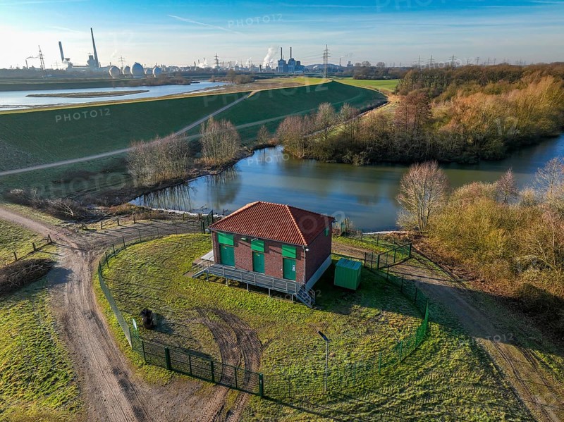 Haltern-Marl, North Rhine-Westphalia, Germany - Lippe, flood protection in the Haltern-Lippramsdorf-Marl area (HaLiMa) . Flood protection on the River Lippe by relocating the dyke and thus extending the floodplain. In front, the Haltern-Meinken pumping station on the completed floodplain north, the north dyke. Work is still underway on the south dyke. In the back: Marl Chemical Park