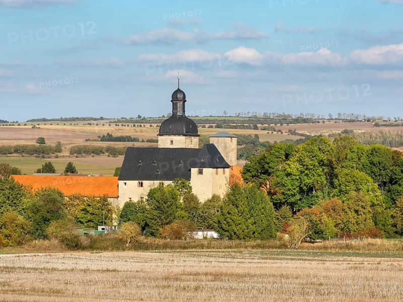 View over stubble field to Zilly Castle in the Harz foothills, Osterwieck, Saxony-Anhalt, Germany