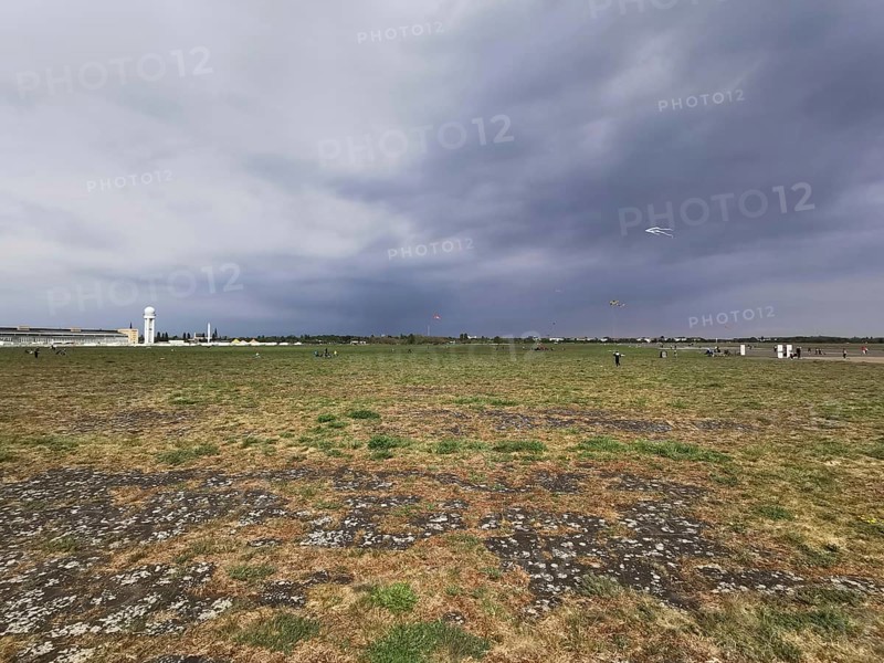 Cloudy sky over a wide field with flying dragons, Tempelhofer Feld in autumn, Berlin