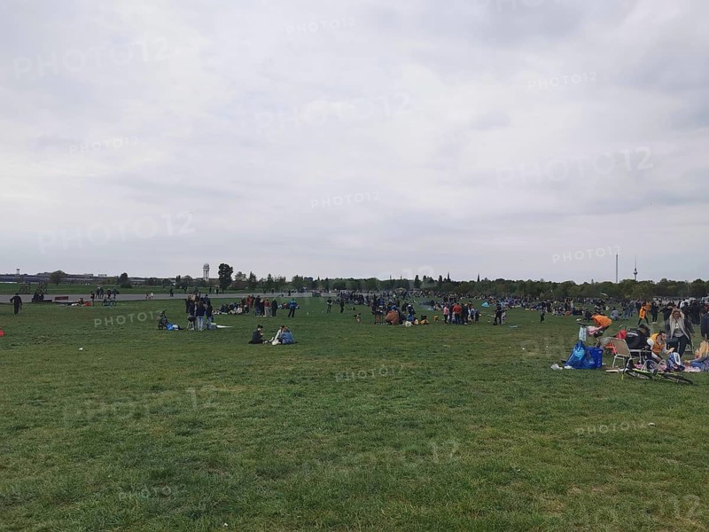 Extensive Tempelhofer Feld with people enjoying free time on a large meadow, Berlin