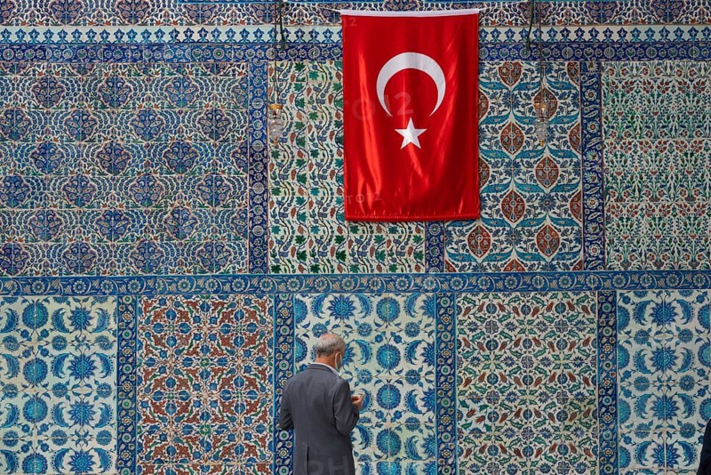 Istanbul, Turkey. 12th October 2021 A man prays in front of beautiful Iznik tiles outside the tomb of Abu Ayyub al-Ansari in the Eyup Sultan mosque on the banks of the Golden Horn on the European side of Istanbul, Turkey