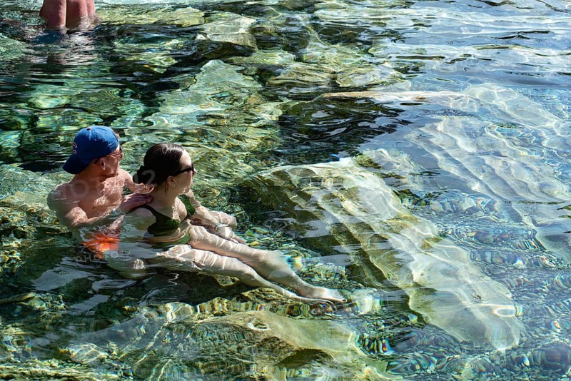 Pamakkale, Turkey, April 25th 2020 Tourists enjoy the healing properties of thermal waters among fallen Roman columns in Cleopatra's Antique Pool in Pamakkale