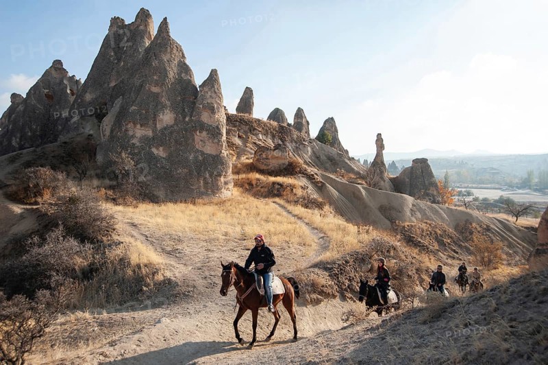Cappadocia, Turkey. November 8th 2017 Canan leads a group of tourist's horse trekking through the volcanic landscape of Cappadocia in central Anatolia, Turkey