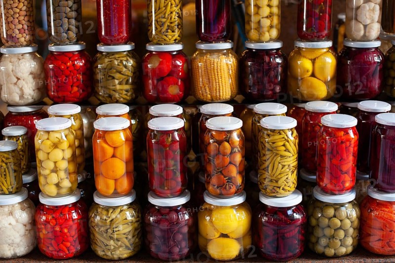 Brightly colored jars of Turkish Tursu, pickled vegetables for sale in an Istanbul Bazar, Turkey