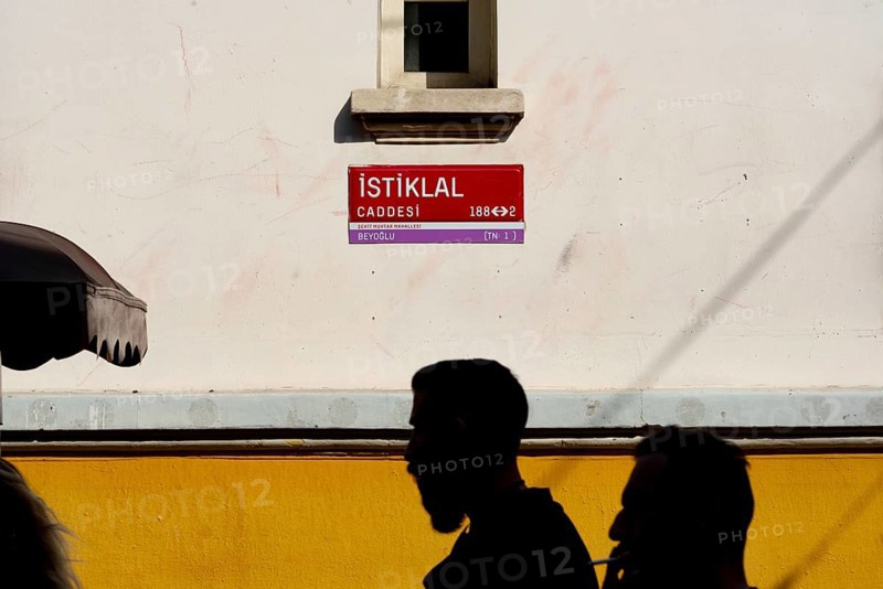 Istanbul, Turkey. September 18th 2021 Iconic street sign for the famous main shopping avenue of Istiklal Street with silhouette of passing shoppers, Taksim, Istanbul, Turkey