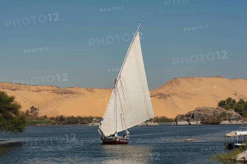 Aswan, Egypt. December 10th 2022 Beautiful landscape view of an Egyptian Felucca sail boat along the River Nile at Elephantine Island, A Nubian Village in Upper Egypt
