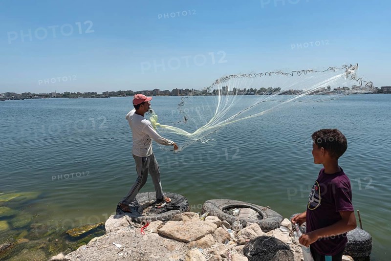 Rosetta, Egypt. June 27th 2024 A local Egyptian fishermen castes his weighted net into the River Nile at Rosetta in the Nile Delta in Northern Egypt