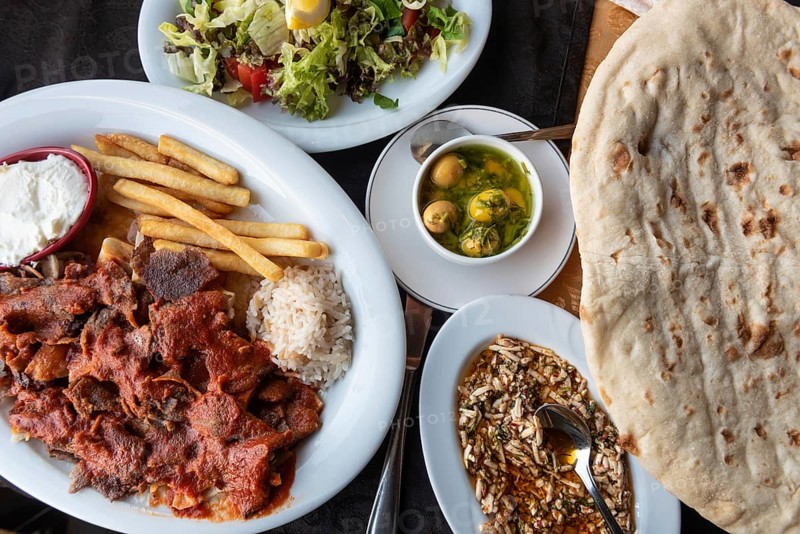 Alanya, Turkey. April 8th 2021 Plate of Iskender or Bursa Kebab with a Turkish mezze and traditional bread. Typical local cuisine in Turkey