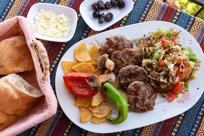 Typical Turkish meal of Kofte with green pepper, mushroom, salad and French fries