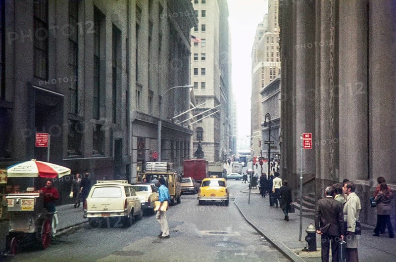 Yellow taxi cab driving down Wall Street toward Broadway, Financial District of Lower Manhattan, New York City, USA 1976