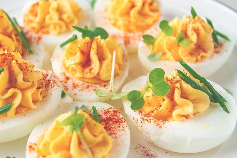 Stuffed eggs with paprika, on a plate, close-up