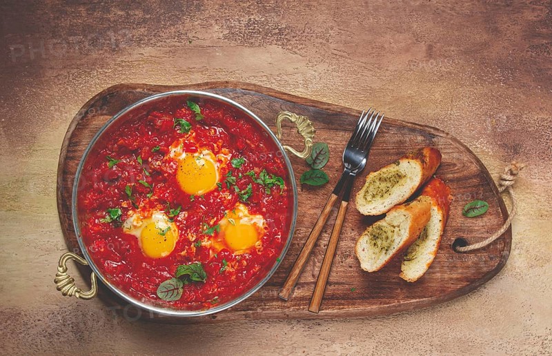 Shakshuka, breakfast, fried eggs in tomato sauce, with spices and herbs, homemade, no people