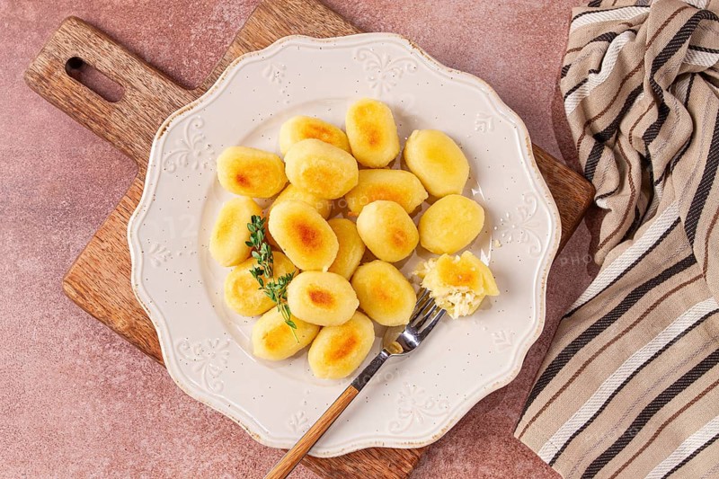 Stuffed gnocchi with cheese, Italian dumplings, garnished with parmesan cheese, no people