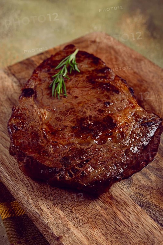 Grilled steak, beef steak, rib eye steak, on a chopping board, top view, no people