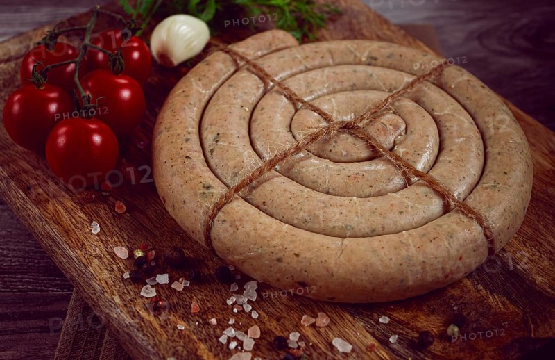 Raw spiral sausages, on a wooden board, top view, no people