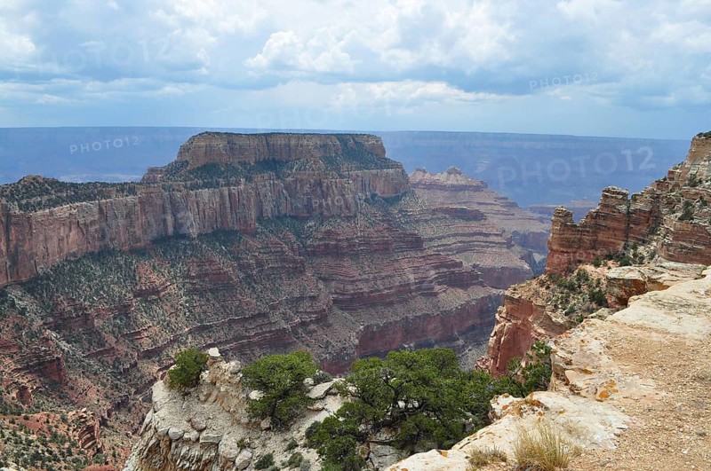 Extensive view of a canyon with deep valleys and steeply sloping cliffs under a cloudy sky, Grand Canyon National Park, Arizona, USA