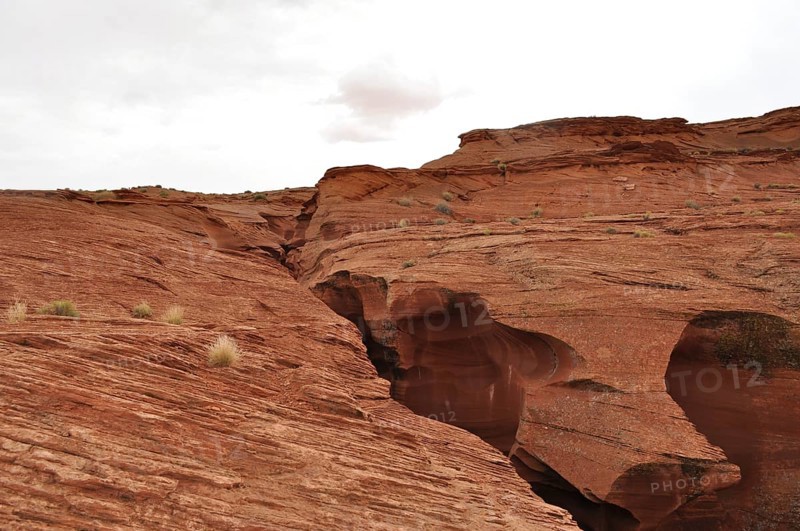 Wide rocky landscape with heavily eroded sandstone formations and a cloudy sky, Antelope Canyon, Navajo Nation Reservation, Lake Powell Tribal Park, Arizona, USA
