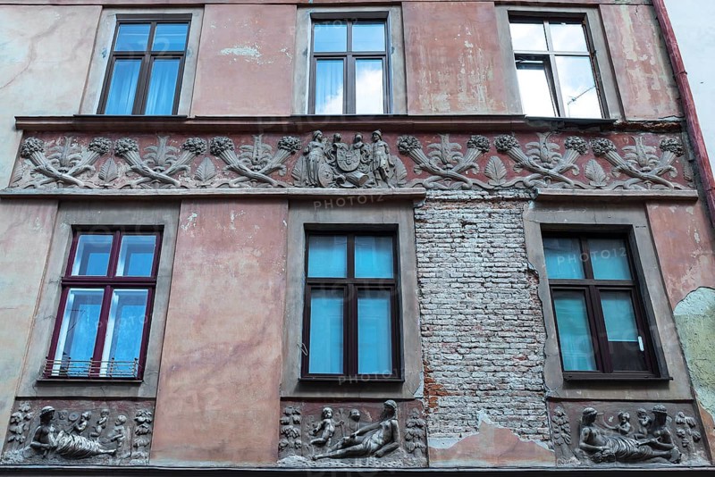 Relief band with cornucopias and figures on a dilapidated house façade from the 19th century, Lemberg, Ukraine
