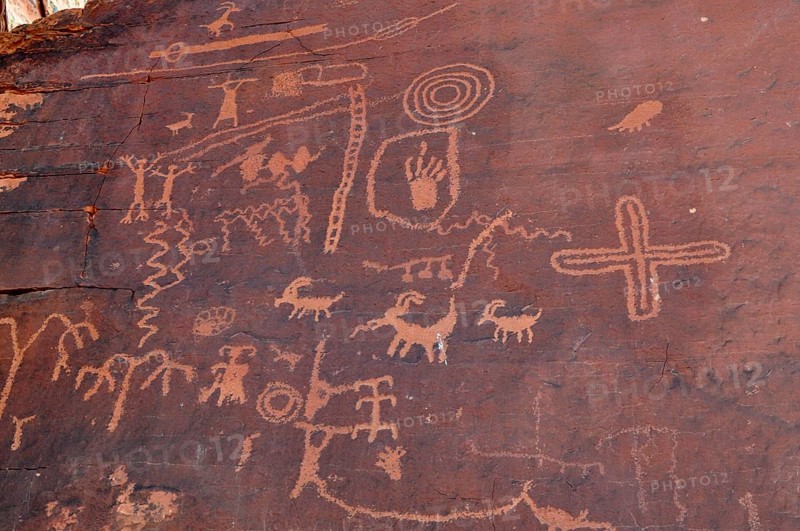 Ancient petroglyphs and symbols engraved in rock walls testify to historic art in the desert, Valley of Fire State Park, Nevada, USA