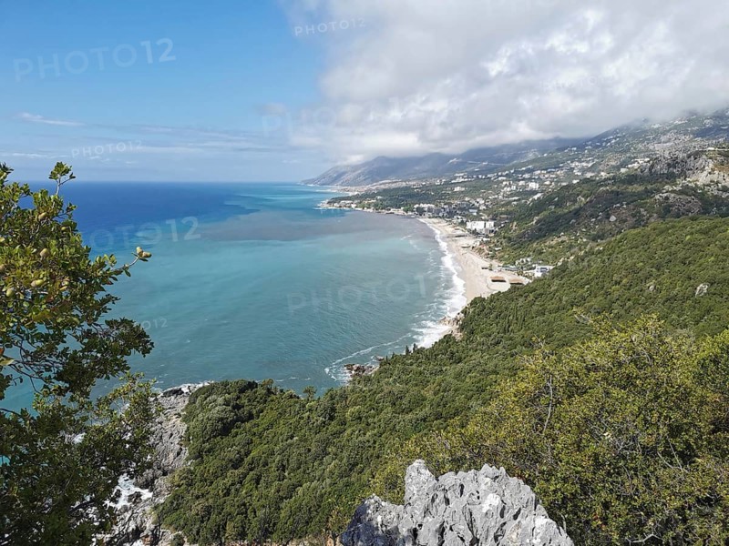 Extensive view of a coastal town surrounded by forests and mountains, Dhermi, Albanian Riviera, Albania