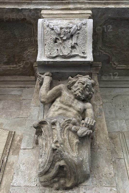 Sculpture of a man, Atlant under a 19th century balcony, Lviv, Ukraine