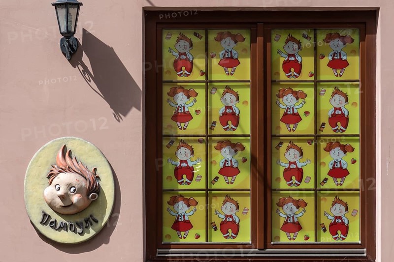 Window of a toy store covered with children's comics, Lviv Ukraine