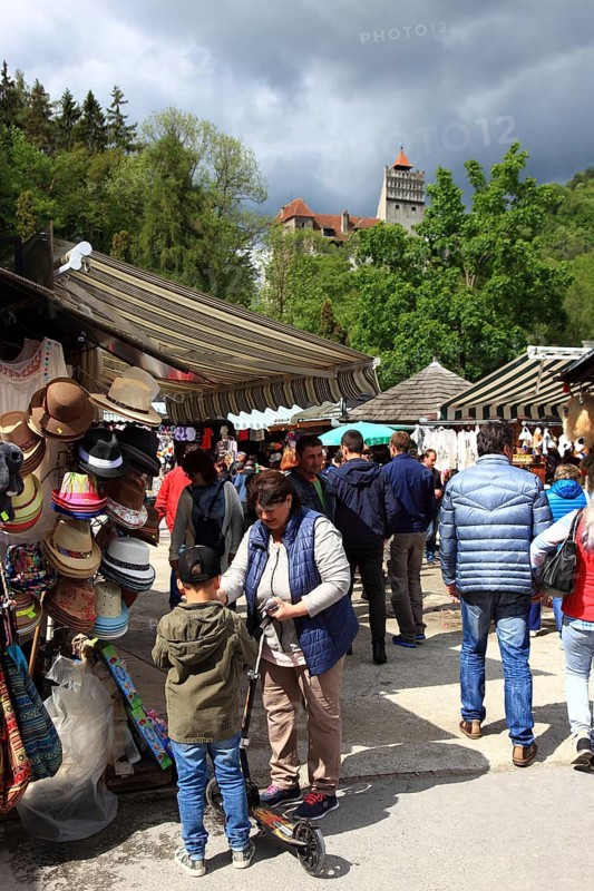 Souvenir sale at Bran Castle, market stalls in front of the entrance, tourists, Törzburg, in Transylvania, Romania. It is famous as Dracula's Castle and one of the country's main attractions